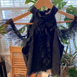 Black crop top blouse, zips up in the back, with fine lace detail